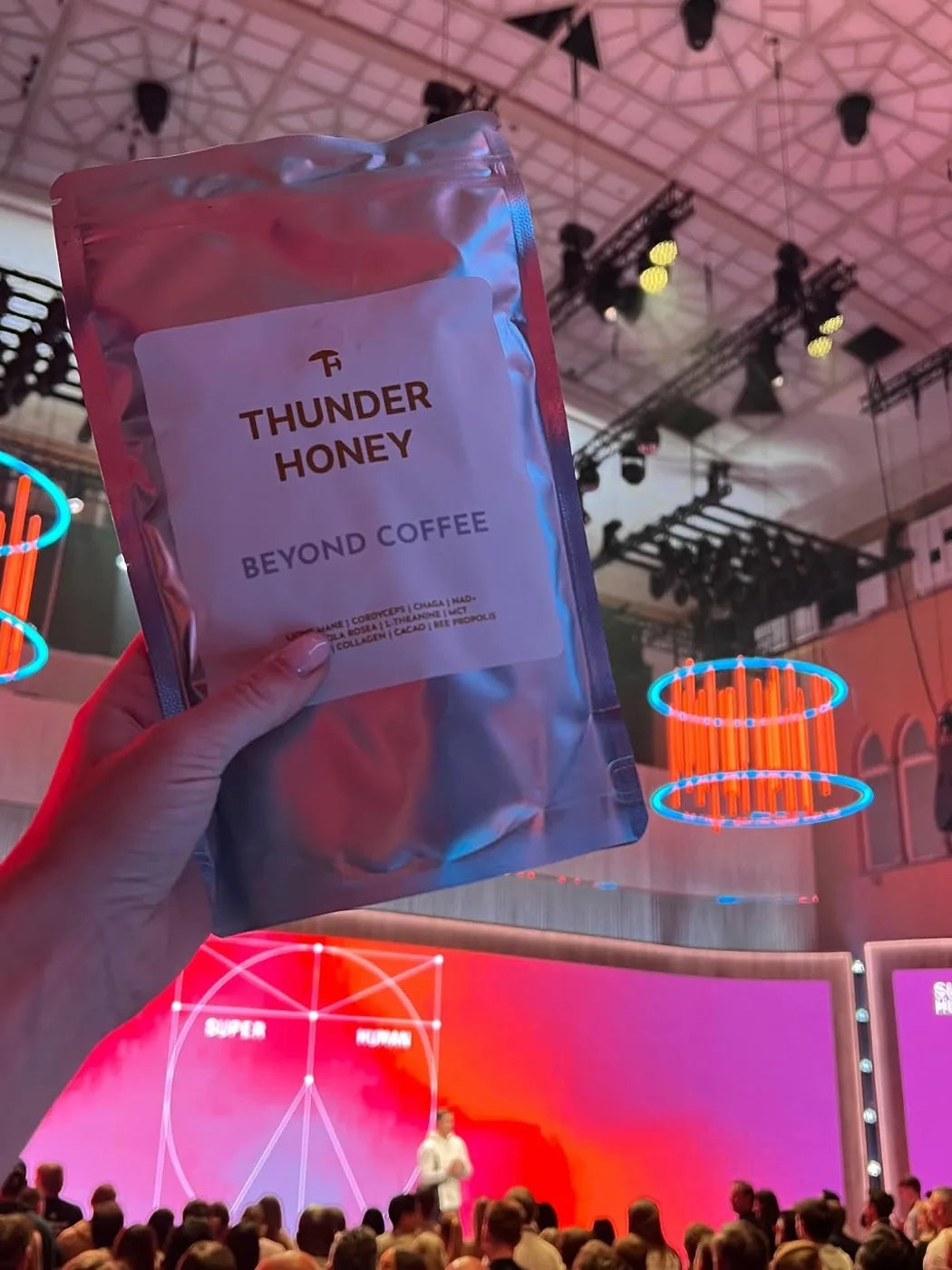 A guest holding the Thunder Honey pouch at the Super Human event