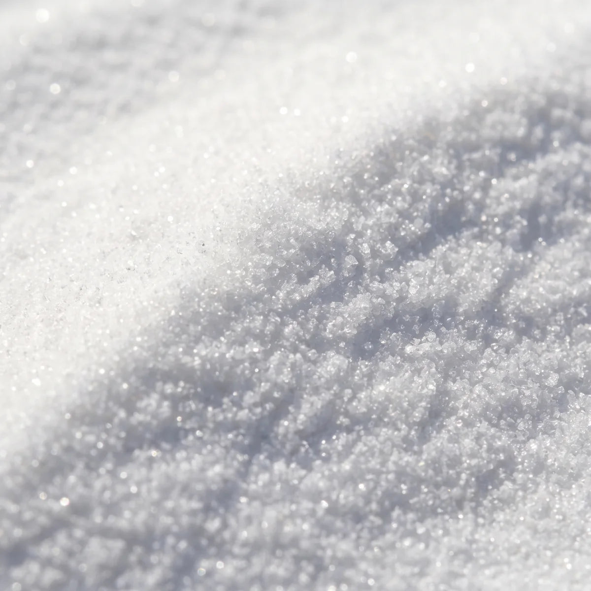 Nicotinamide riboside up close, a fine white crystalline powder catching the light