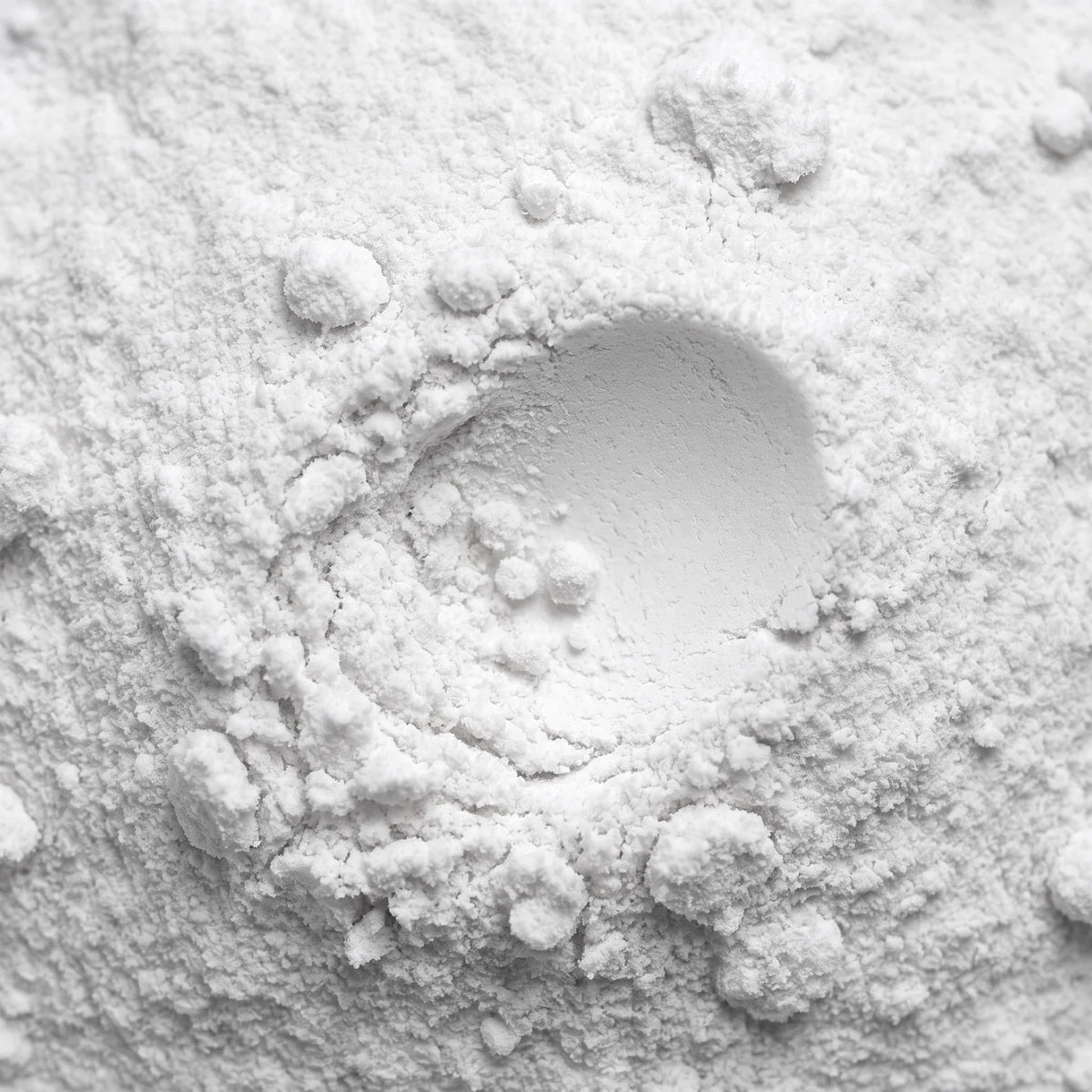 CDP-Choline up close, a soft matte ivory powder with a small hollow pressed into it