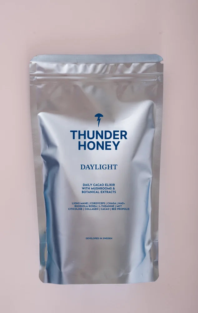 The Thunder Honey Daylight pouch, silver foil with the navy wordmark